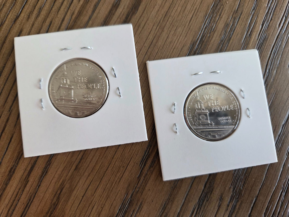 2026 P and D We the People U.S. Constitution quarter pair, reverse, photographed in coin holders